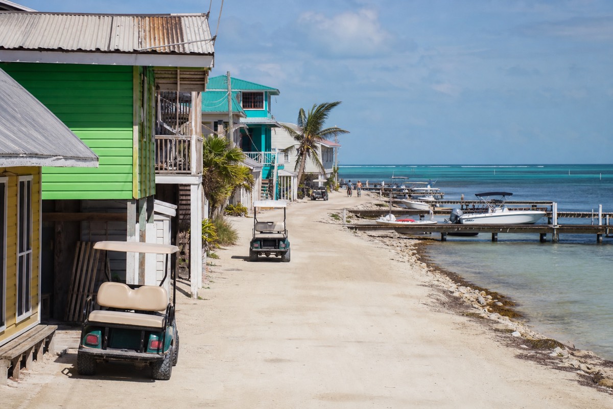 Boats moored off the San Pedro waterfront, a popular base for snorkeling in Ambergris Caye, with the reef line breaking offshore