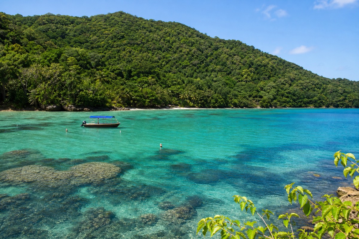 Clear turquoise water over coral heads, a highlight of Belize snorkeling tours inside the barrier reef