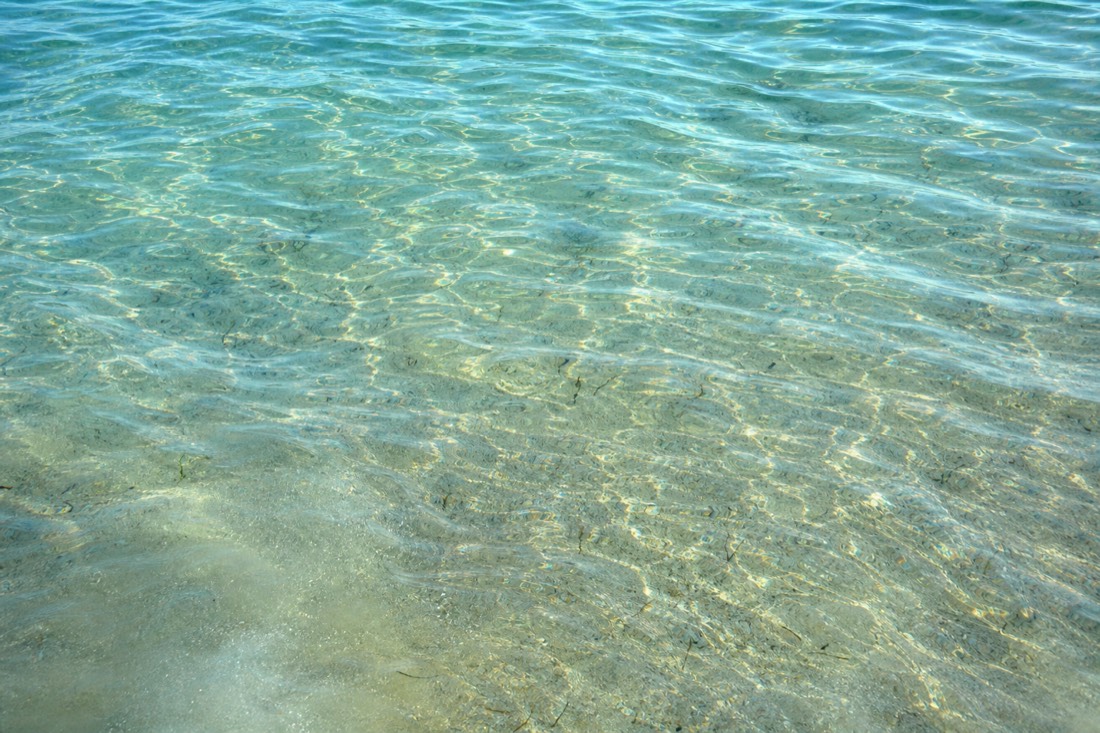 Turquoise water over the Belize Barrier Reef, where most snorkel tours at Lighthouse Reef Atoll cross open water